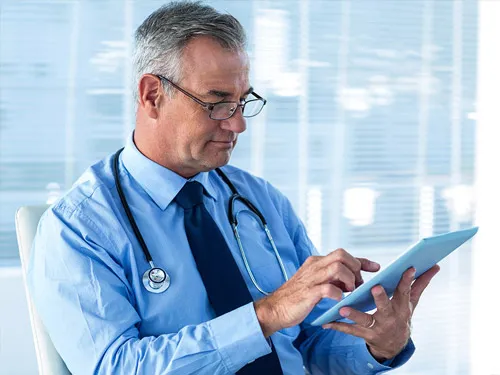 Clinician reviewing a patient's medical history on a tablet